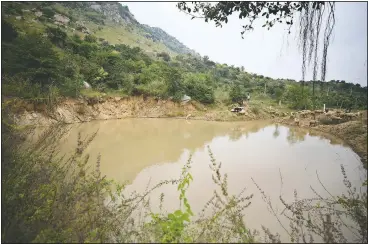  ??  ?? A villager arrives with his sheep at one of the 16 ponds created by Kamegowda.