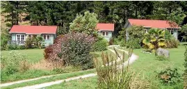  ??  ?? The idyllic cottages at Po¯hara in Golden Bay. Right, Siobhan Downes, in her knee brace, picks berries in Motueka during the dreary summer of 2006.