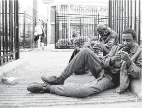  ?? Elizabeth Conley / Staff photograph­er ?? Local men who are homeless hang out on Main Street in downtown Houston. Some feel they’ve been left out of the coronaviru­s prevention measures.