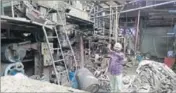  ??  ?? A man showing the damaged machinery of Vishal Paper Mill at Malerkotla in Sangrur on Monday. BHARAT BHUSHAN/HT