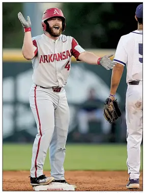  ?? NWA Democrat-Gazette/ANDY SHUPE ?? Arkansas’ Trevor Ezell celebrates after driving in a run with a double in the Razorbacks’ victory over TCU on Saturday at the NCAA Fayettevil­le Regional. The Hogs will advance to the super regionals with a victory today.