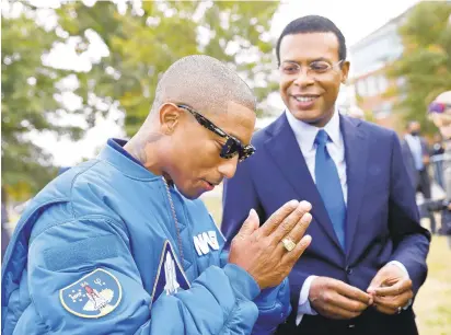  ?? JONATHON GRUENKE/STAFF ?? Pharrell Williams and Norfolk Mayor Kenny Alexander, left, speak to media before the start of a forum to discuss diversity and inclusion in business at Norfolk State University on Thursday.