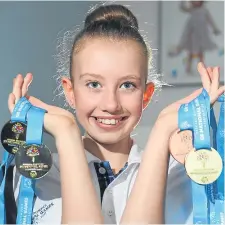  ??  ?? Taylor MacKenzie with the medals she won in Sheffield.