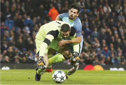  ??  ?? MANCHESTER: Manchester City’s Nolito, right, and Celtic’s goalkeeper Craig Gordon challenge for the ball during the Champions League group C soccer match between Manchester City and Celtic at the Etihad stadium in Manchester, England, yesterday. — AP