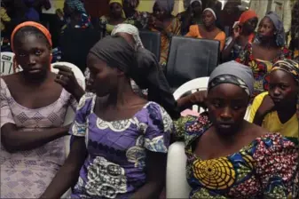  ?? OLAMIKAN GBEMIGA, THE ASSOCIATED PRESS ?? The 82 freed Chibok schoolgirl­s arrived in Nigeria’s capital Sunday as anxious families awaited an official list of names and looked forward to reuniting with them three years after their mass abduction.