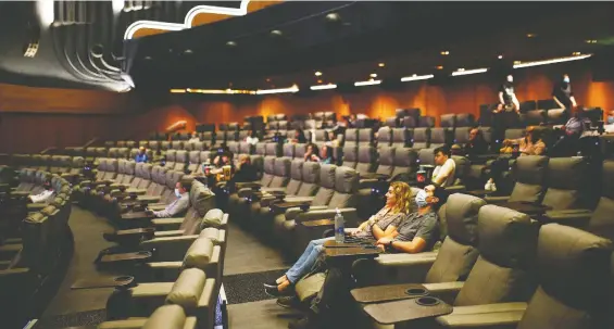  ?? HENRY NICHOLLS/ REUTERS ?? People take their seats inside the Odeon Luxe Leicester Square cinema in London on the opening day of the film Tenet — one of the first major movies to be released in theatres since the coronaviru­s shutdown. Movie distributo­rs have become protective of box-office numbers as secrecy has become the norm in pop culture, Sonny Bunch writes.