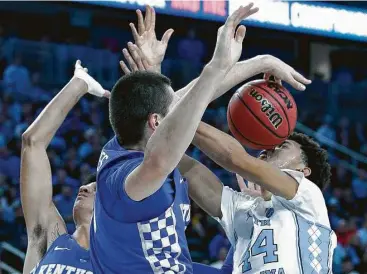  ?? John Locher / Associated Press ?? Kentucky’s Isaac Humphries blocks North Carolina’s Justin Jackson, right, during the first half of the game Saturday in Las Vegas. Jackson had 34 points in a losing cause for the Tar Heels.