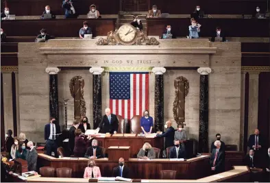  ?? Pool / Getty Images ?? House Speaker Nancy Pelosi and Vice President Mike Pence preside over a joint session of Congress to certify the 2020 Electoral College results on Wednesday before violence erupted at the Capitol.