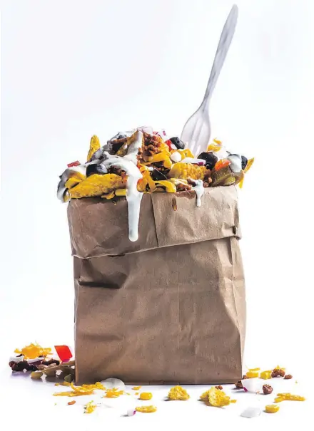  ??  ?? Chef Kristin Kish’s Nachos in a Bag combine Mexican-spiced ground beef with chips, cheese and more in a fun, unconventi­onal receptacle. Serve with disposable forks and cleanup is a snap.