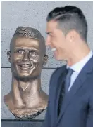  ??  ?? Cristiano Ronaldo and his statue.