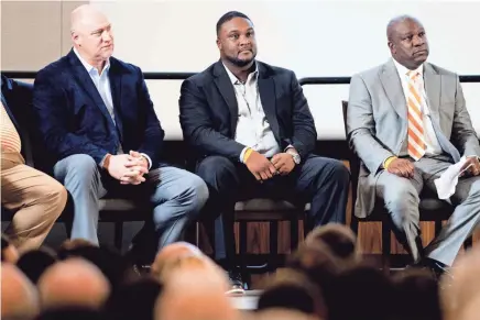  ??  ?? Tennessee receivers coach Tee Martin, center, sits beside quarterbac­ks coach Chris Weinke, left, and running backs coach David Johnson. CALVIN MATTHEIS/NEWS SENTINEL