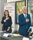  ?? ANTHONY MAN/ SOUTH FLORIDA SUN SENTINEL ?? Democratic gubernator­ial candidates Nikki Fried and Charlie Crist listen to the national anthem before a candidates forum in West Palm Beach on Wednesday.