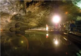  ?? ASSOCIATED PRESS FILE PHOTO BY WADE PAYNE ?? Guests board glass-bottom boats to tour the Lost Sea in Sweetwater, Tenn. The cave surroundin­g the world’s second largest undergroun­d lake stays at a constant 58 degrees.