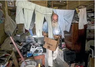  ??  ?? Father Pablo Zabala, better known as Padre Pablo, cleans up the sleeping quarters where he resides in Boca Colorado, part of Peru’s Madre de Dios region in the Amazon.