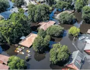  ?? Brett Coomer / Houston Chronicle ?? Harvey’s floodwater­s envelop houses in Vidor. The national flood insurance program is running a deficit.