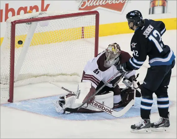  ?? — GETTY IMAGES ?? Jets’ Olli Jokinen scores the deciding goal on Coyotes’ Mike Smith in Winnipeg’s 3-2 shootout win on home ice on Thursday.