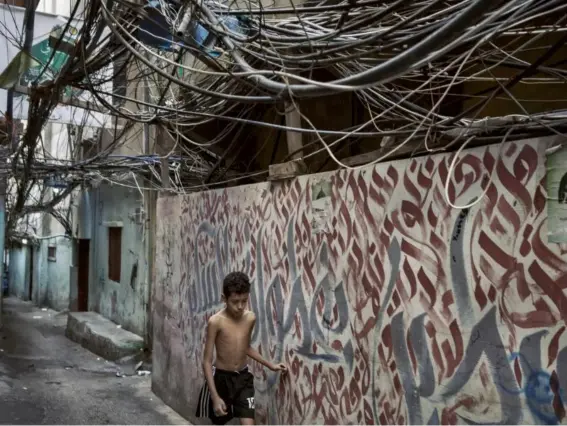  ?? (Photos: The Washington Post) ?? The Bourj el-Barajneh refugee camp suffered throughout Lebanon’s civil war, with nearly a quarter of the camp’s population displaced