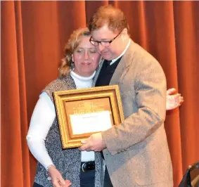  ?? Photo by Kate Stow ?? ■ Buddy Deese is congratula­ted by his wife after being inducted into the Fourstates Bandmaster­s Hall of Fame.