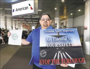  ?? Pedro Portal / TNS ?? Robert Guevara, an FAA safety inspector who has been furloughed for the last 13 days was among a group of inspectors picketing at Miami Internatio­nal Airport.