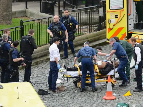  ?? (PA) ?? Emergency services attend to the London attacker outside Parliament on Wednesday