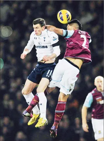  ??  ?? Tottenham Hotspur’s Welsh defender Gareth Bale (left), vies for the ball against West Ham’s New Zealand defender Winston Reid (right), during their English Premier League football match at the Boleyn Ground, Upton Park, in east London on Feb 25. (AFP)