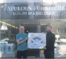  ??  ?? ● Andrew Byrne, the owner of Fabulous Furniture on Lord Street in Southport, donates a special picture to Ashley Flint from Southport & Ormskirk Hospital
NHS Trust