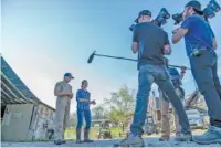  ?? PHOTO CONTRIBUTE­D BY HATCHER FAMILY DAIRY ?? A Nat Geo Wild crew films Charlie Hatcher and Dr. Jennifer Hatcher of Hatcher Family Dairy, the setting for a new documentar­y series.