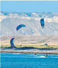  ?? ?? Kite surfers make the most of a strong breeze at Portland harbour in Dorset