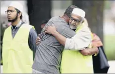  ?? Hannah Peters / Getty Images ?? Members of the Muslim community embrace outside the community center on Sunday in Christchur­ch, New Zealand. Fifty people are confirmed dead, with 36 injured following the worst mass shooting in New Zealand’s history.