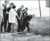  ?? AP/DMITRY LOVETSKY ?? Internatio­nal forensic experts visit the crash site of Malaysia Airlines Flight 17 on Monday at Hrabove, Donetsk region, eastern Ukraine.