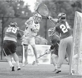  ?? BRIAN KRISTA/BALTIMORE SUN MEDIA GROUP ?? Patterson Mill’s Kevin Dyke fires a shot against Sparrows Point goalie Zach Barnickel.