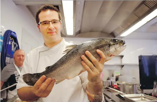  ?? STEVE MACNAULL/FOR POSTMEDIA NEWS ?? Chef Nicolas Zearo shows off the trout from the nearby Adour River that will be sautéed in a cooking class at the Grand Hotel de Bordeaux.