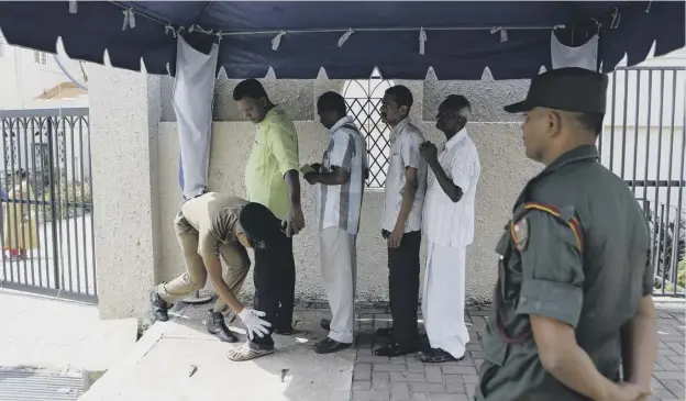  ?? PICTURE: AP ?? 0 A Sri Lankan government soldier body searches devotees entering a Catholic church to attend mass in Colombo
