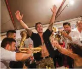  ??  ?? People enjoy trumpet music during the trumpet and brass band festival in the Serbian village of Guca, about 160 km (100 miles) south of Belgrad. — AFP photos