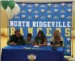  ?? JON BEHM — THE MORNING JOURNAL ?? North Ridgeville senior Izzy Geraci signs her national letter of intent to play basketball at Cleveland State as her family watches on Nov. 8. Geraci is the first North Ridgeville girls basketball player to commit to a Division I college.