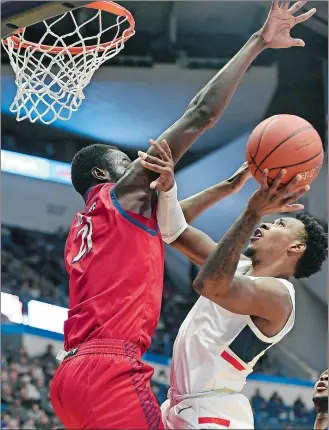  ?? STEPHEN DUNN/AP PHOTO ?? UConn’s Christian Vital, front right, shoots against New Jersey Institute of Technology’s Souleymane Diakite (21) in the second half of Sunday’s game at the XL Center in Hartford.