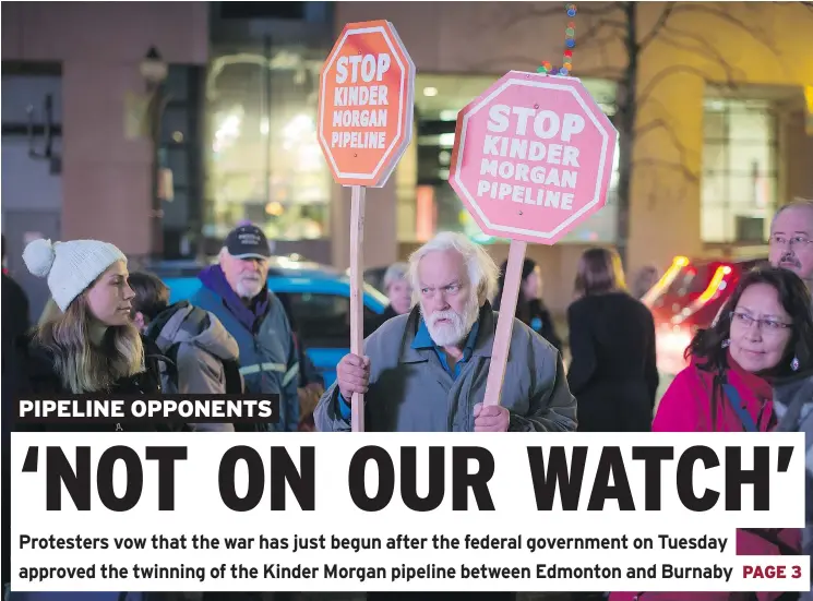  ?? — THE CANADIAN PRESS ?? Environmen­tal activist Paul George holds signs during a protest Tuesday in Vancouver against the Kinder Morgan Trans Mountain pipeline expansion.