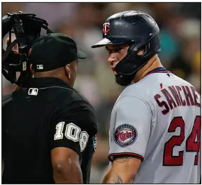  ?? GREGORY BULL / AP FILE (2022) ?? Minnesota’s Gary Sanchez has a word with Moore after striking out July 29, 2022, in San Diego. Moore began umpiring as a 20-year-old.
