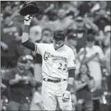  ?? Associated Press photo ?? Milwaukee Brewers' Christian Yelich reacts after receiving a standing ovation from the crowd after hitting a triple to complete the cycle during the sixth inning of a baseball game against the Cincinnati Reds, Monday in Milwaukee.