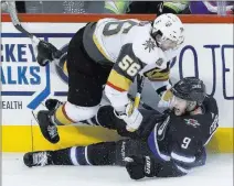  ?? John Woods ?? The Canadian Press Erik Haula of the Knights has his landing softened by Winnipeg’s Andrew Copp in the third period Thursday in Winnipeg.