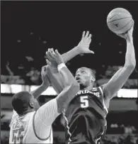  ?? AP/ERIC GAY ?? Michigan State center Adreian Payne (5) shoots over Texas’ Cameron Ridley (55) during the second half of Saturday’s game in Austin, Texas. Payne scored a career-high 32 points and No. 5 Michigan State won 92-78.