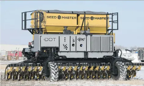  ?? TROY FLEECE ?? DOT, an autonomous power platform, carries a 30-foot air drill at the SeedMaster head office in Emerald Park. DOT can be hooked up to many different pieces of farm equipment, making driverless agricultur­al work using GPS technology a reality for...