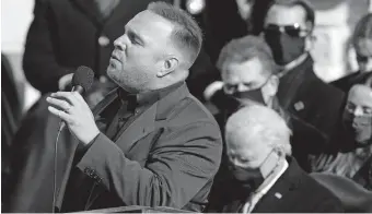  ??  ?? Oklahoma native Garth Brooks sings “Amazing Grace” as President Joe Biden listens during the 59th Presidenti­al Inaugurati­on on Wednesday at the U.S. Capitol in Washington. [AP PHOTO]