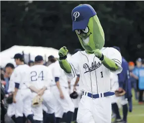  ?? — THE OREGONIAN FILES ?? Mascot Dillon the Pickle is indicative of the quirkiness that abounds in minor baseball leagues throughout the U.S.