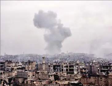  ?? GEORGE OURFALIAN/AFP ?? Smoke rises from buildings yesterday in Aleppo’s eastern al-Shaar neighbourh­ood as Syrian pro-government troops advance towards the area through Karm al-Jabal district during their offensive to retake Syria’s second city.