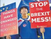  ?? AFP/FILE ?? An anti-Brexit demonstrat­or holds placards as he protests outside the British Parliament in London.