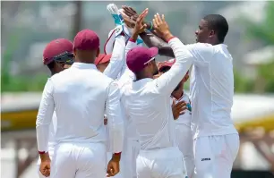  ?? — AFP ?? West Indies players celebrate the wicket of Shadab Khan.