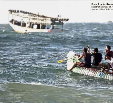  ??  ?? From litter to lifesaver: Muath and his friends riding on his boat that he made of 70 southern Gaza Strip. —