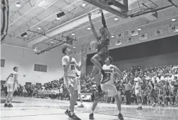  ?? MINGSON LAU/THE REPUBLIC ?? Perry’s Cody Williams dunks against Basha at Basha High School on Jan. 16 in Chandler.