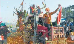  ??  ?? Farmers shower flower petals on fellow protesters at Singhu border.